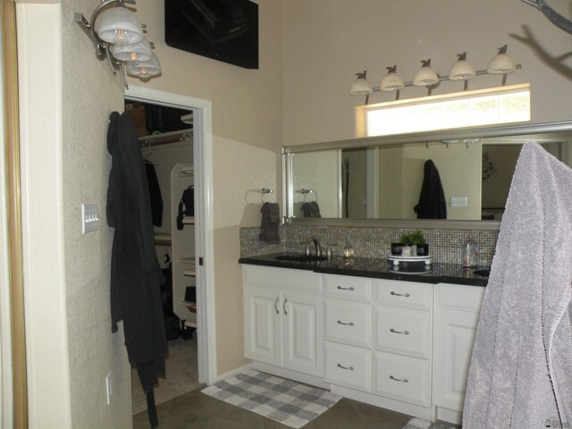 10224 S Fairway Ln, Yuma, AZ 85367 - bathroom featuring backsplash, double vanity, tile patterned floors, and a spacious closet