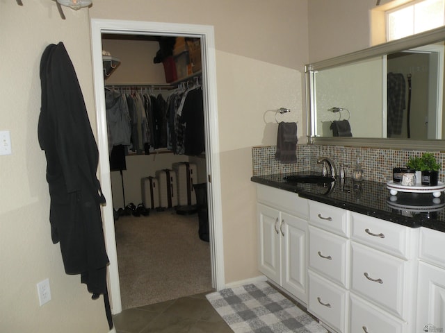 10224 S Fairway Ln, Yuma, AZ 85367 - bathroom featuring a walk in closet, tasteful backsplash, vanity, and tile patterned flooring