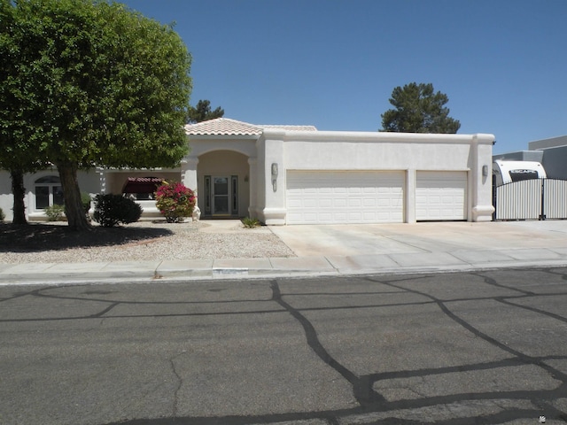 10224 S Fairway Ln, Yuma, AZ 85367 - view of front of property featuring an attached garage, stucco siding, concrete driveway, and a gate