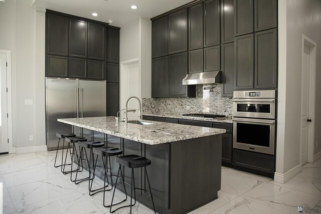 12815 S Greenview Way Greenview Way, Yuma, AZ 85365 - kitchen featuring light marble finish floors, stainless steel appliances, light stone countertops, recessed lighting, and decorative backsplash