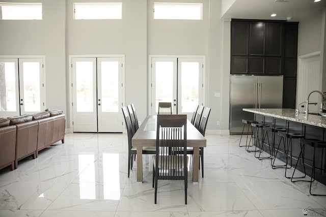 12815 S Greenview Way Greenview Way, Yuma, AZ 85365 - dining space featuring french doors, light marble finish floors, a towering ceiling, and plenty of natural light