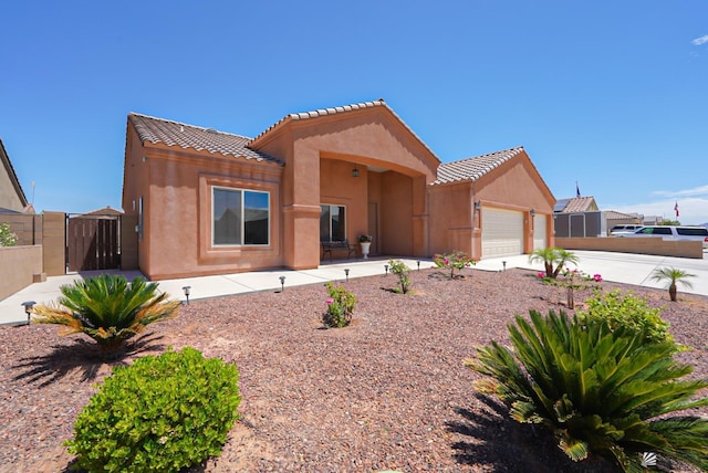 10200 E 39th St, Yuma, AZ 85367 - view of front facade with stucco siding, driveway, a gate, and an attached garage