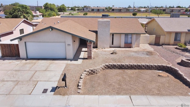 3120 W 16th Pl, Yuma, AZ 85364 - view of front of property featuring a garage, a chimney, concrete driveway, a residential view, and stucco siding