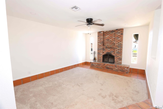 3120 W 16th Pl, Yuma, AZ 85364 - unfurnished living room with carpet, a ceiling fan, tile patterned floors, and a fireplace