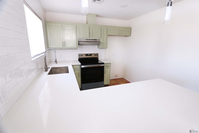 3120 W 16th Pl, Yuma, AZ 85364 - kitchen with electric stove, under cabinet range hood, tasteful backsplash, and light countertops