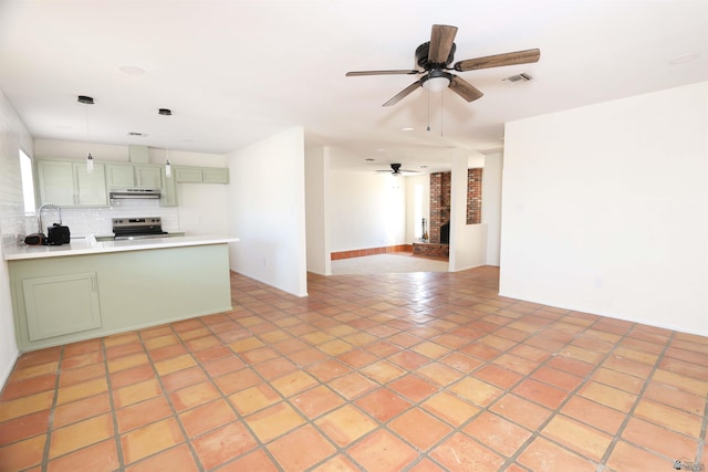3120 W 16th Pl, Yuma, AZ 85364 - kitchen with stainless steel range with electric cooktop, green cabinets, under cabinet range hood, ceiling fan, and a peninsula