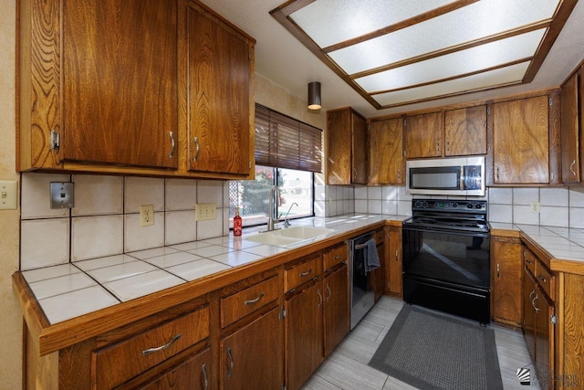 12510 E Del Rico, Yuma, AZ 85367 - kitchen featuring a sink, tile counters, stainless steel microwave, dishwashing machine, and black range with electric stovetop