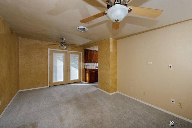12510 E Del Rico, Yuma, AZ 85367 - unfurnished living room with visible vents, a ceiling fan, baseboards, and light carpet