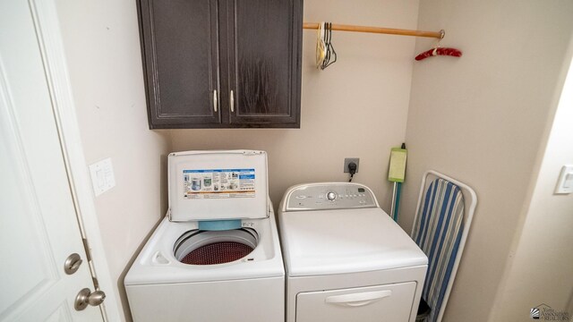 laundry area featuring cabinet space and washing machine and clothes dryer
