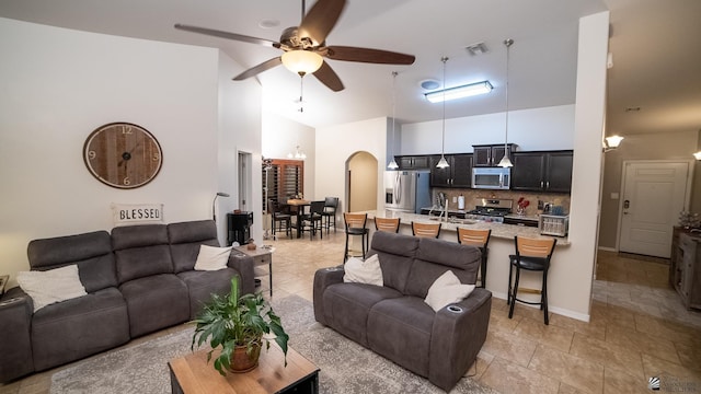 11681 E 36th St, Yuma, AZ 85367 - living area featuring ceiling fan, arched walkways, high vaulted ceiling, light tile patterned floors, and visible vents