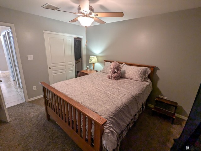carpeted bedroom featuring baseboards, ceiling fan, a closet, and visible vents