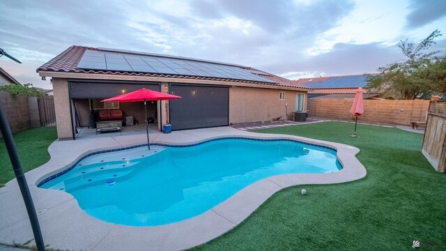 view of pool featuring a fenced in pool, a fenced backyard, a patio area, and central AC