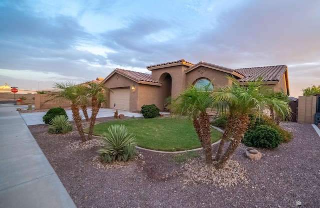 11681 E 36th St, Yuma, AZ 85367 - mediterranean / spanish-style home featuring a tiled roof, driveway, fence, an attached garage, and stucco siding