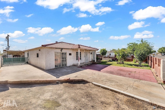 1802 S 11th Ave, Yuma, AZ 85364 - rear view of house featuring a tile roof, a patio, stucco siding, and a fenced backyard
