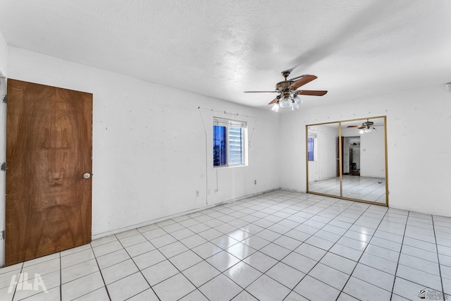1802 S 11th Ave, Yuma, AZ 85364 - unfurnished bedroom featuring a closet, ceiling fan, and light tile patterned flooring