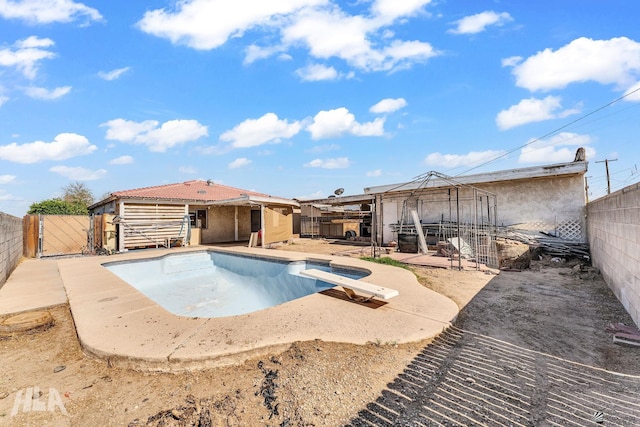 1802 S 11th Ave, Yuma, AZ 85364 - view of swimming pool featuring a fenced backyard, a diving board, a gate, and a patio area