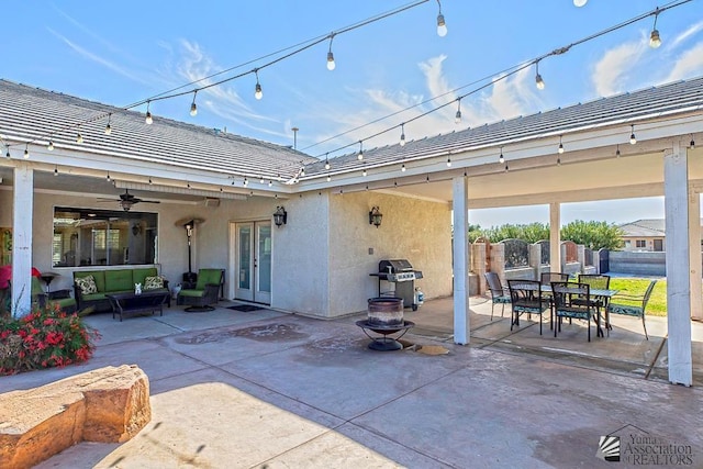 view of patio / terrace featuring fence, a grill, french doors, an outdoor living space, and a ceiling fan
