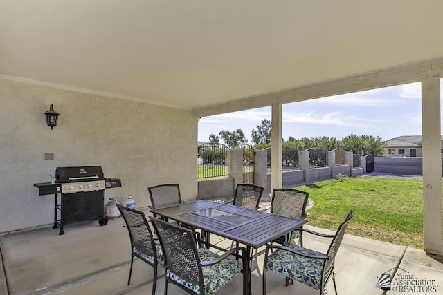view of patio / terrace featuring grilling area, fence, a gate, and outdoor dining area
