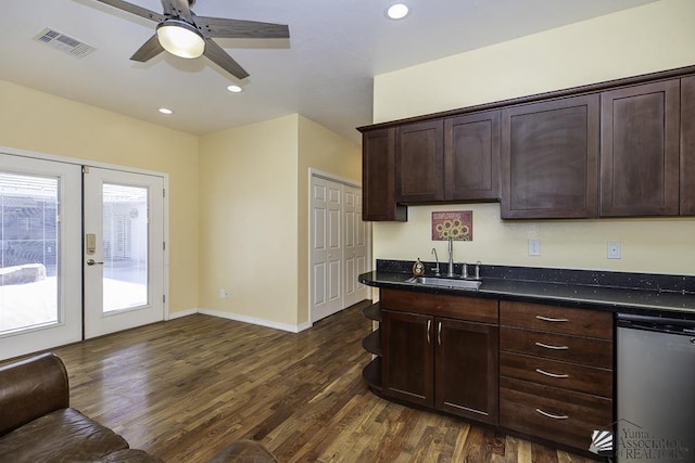 kitchen with dark brown cabinetry, visible vents, dark wood-style floors, and a sink