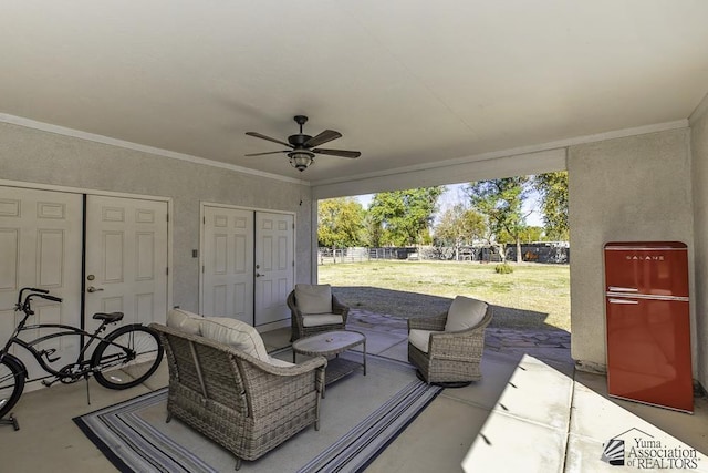 view of patio / terrace with an outdoor living space, a ceiling fan, and fence