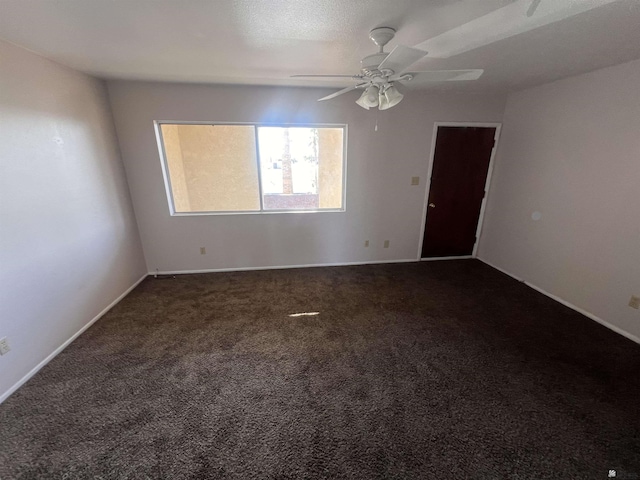2801 S 1st Ave, Yuma, AZ 85364 - empty room featuring dark carpet, a ceiling fan, and baseboards