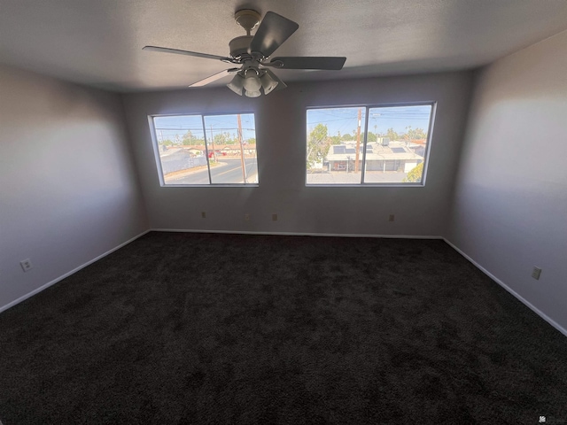 2801 S 1st Ave, Yuma, AZ 85364 - spare room with ceiling fan, dark colored carpet, and baseboards