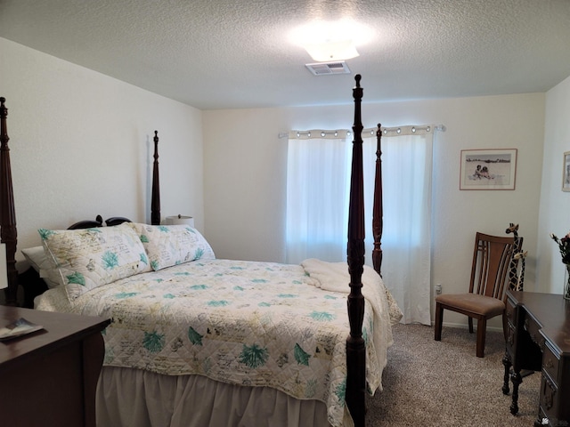 carpeted bedroom featuring a textured ceiling and visible vents