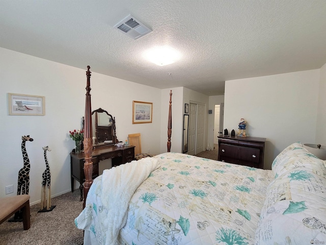 bedroom with carpet floors, baseboards, a textured ceiling, and visible vents