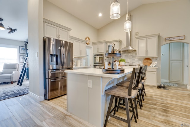 2125 S Bluffs Way, Yuma, AZ 85365 - kitchen with stainless steel fridge, light countertops, an island with sink, backsplash, and wall chimney range hood
