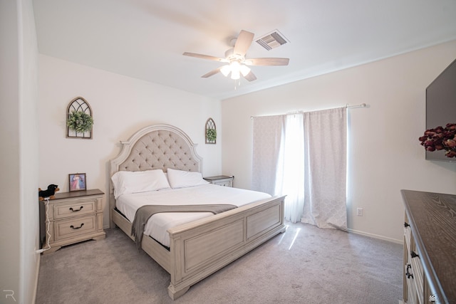 bedroom with light colored carpet, a ceiling fan, baseboards, and visible vents