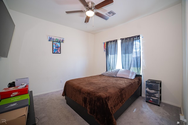 carpeted bedroom with baseboards, a ceiling fan, and visible vents