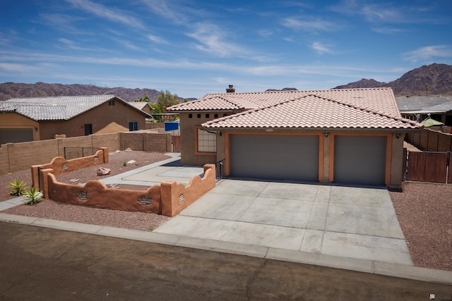 12839 S Drucilla Ln, Yuma, AZ 85367 - view of front of home with a mountain view, a tiled roof, concrete driveway, and a garage