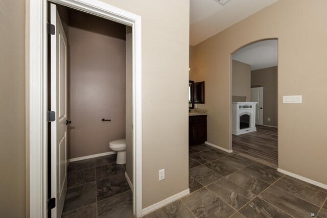 12839 S Drucilla Ln, Yuma, AZ 85367 - bathroom featuring toilet, vanity, marble look tiles, and baseboards