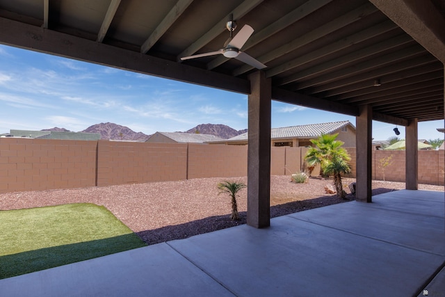 12839 S Drucilla Ln, Yuma, AZ 85367 - fenced backyard featuring a ceiling fan, a patio area, and a mountain view