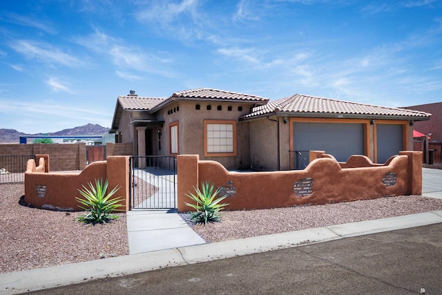 12839 S Drucilla Ln, Yuma, AZ 85367 - view of front facade with a fenced front yard, a tiled roof, a gate, stucco siding, and a garage