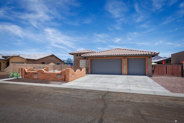 12839 S Drucilla Ln, Yuma, AZ 85367 - view of front of home featuring driveway, a garage, stucco siding, and a tiled roof