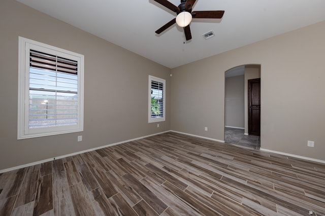 12839 S Drucilla Ln, Yuma, AZ 85367 - unfurnished room featuring ceiling fan, arched walkways, wood finished floors, lofted ceiling, and baseboards