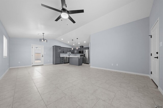 10858 E 45th Ln, Yuma, AZ 85367 - unfurnished living room featuring lofted ceiling, a ceiling fan, light tile patterned floors, a sink, and a chandelier