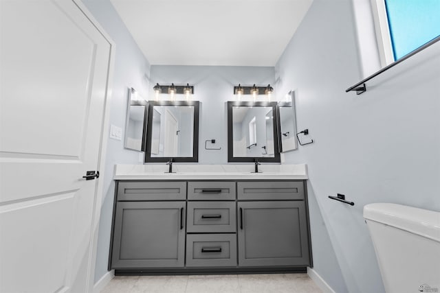 10858 E 45th Ln, Yuma, AZ 85367 - full bath featuring double vanity, baseboards, toilet, and tile patterned flooring
