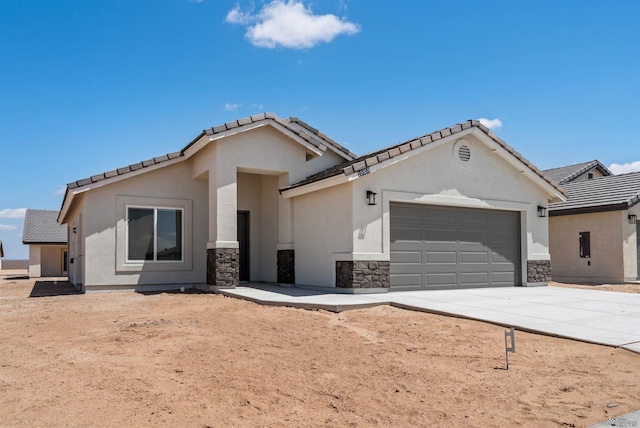 10858 E 45th Ln, Yuma, AZ 85367 - ranch-style home featuring an attached garage, driveway, stucco siding, stone siding, and a tiled roof