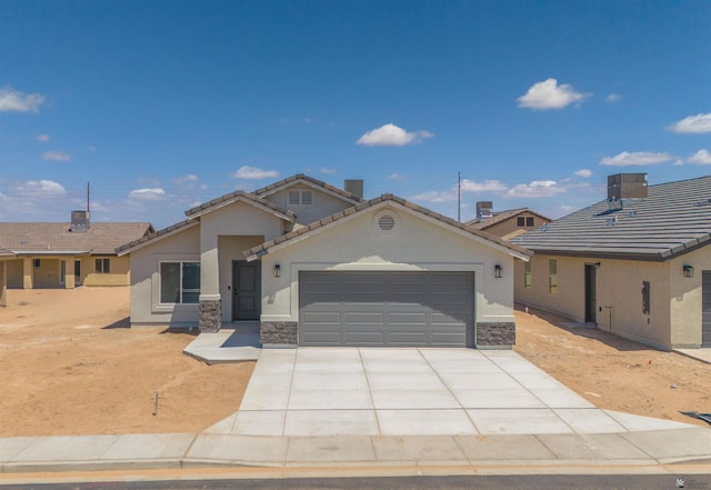 10858 E 45th Ln, Yuma, AZ 85367 - ranch-style house with stucco siding, a garage, driveway, stone siding, and a tiled roof
