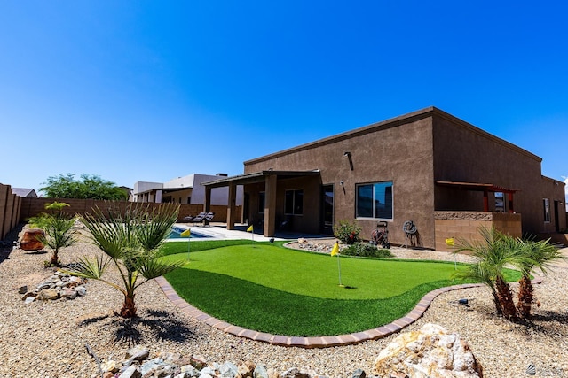 14817 E 47th Dr, Yuma, AZ 85367 - rear view of property featuring a putting area, a patio area, a fenced backyard, and stucco siding