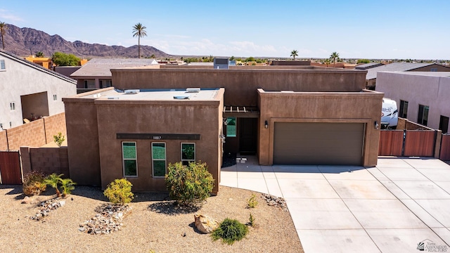 14817 E 47th Dr, Yuma, AZ 85367 - adobe home with driveway, a mountain view, a garage, and stucco siding