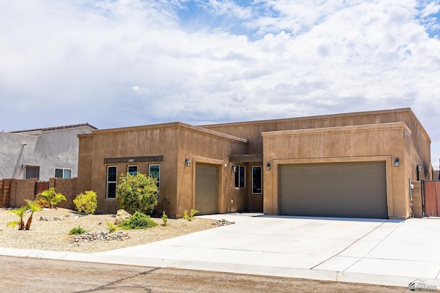 14817 E 47th Dr, Yuma, AZ 85367 - adobe home with an attached garage, stucco siding, and concrete driveway