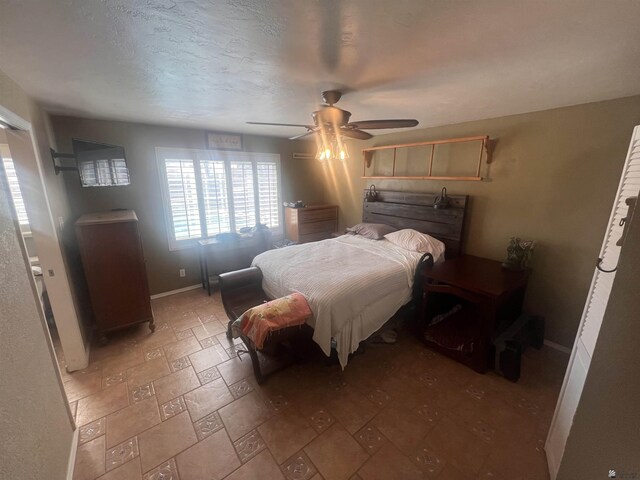 1911 S 11th Ave, Yuma, AZ 85364 - bedroom with light stone finish flooring, baseboards, and a ceiling fan