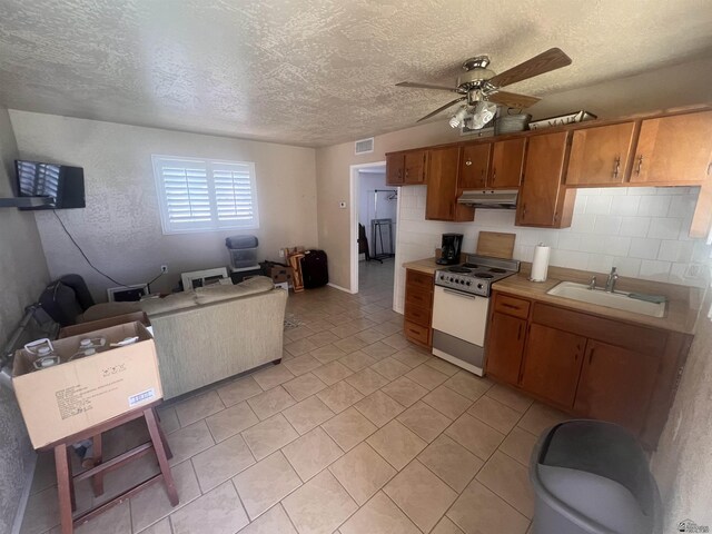 1911 S 11th Ave, Yuma, AZ 85364 - kitchen featuring white electric range oven, a sink, brown cabinets, a ceiling fan, and under cabinet range hood