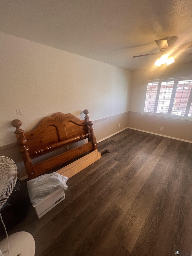 1911 S 11th Ave, Yuma, AZ 85364 - bedroom with dark wood-style flooring, baseboards, a ceiling fan, and a textured ceiling
