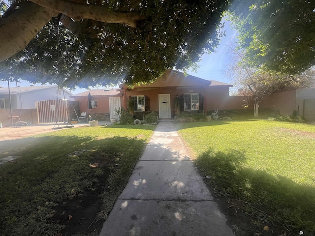 1911 S 11th Ave, Yuma, AZ 85364 - view of front of home with a front yard and stucco siding
