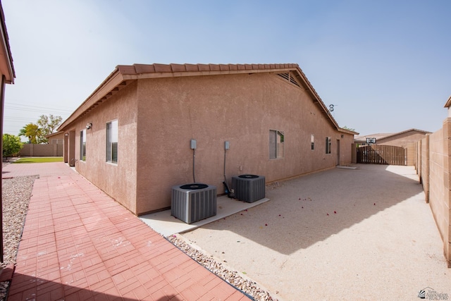 12127 E 35th St, Yuma, AZ 85367 - view of home's exterior featuring a patio, central AC unit, stucco siding, and a fenced backyard