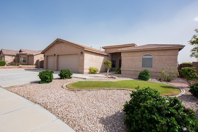 12127 E 35th St, Yuma, AZ 85367 - view of front of house with stucco siding, an attached garage, and driveway